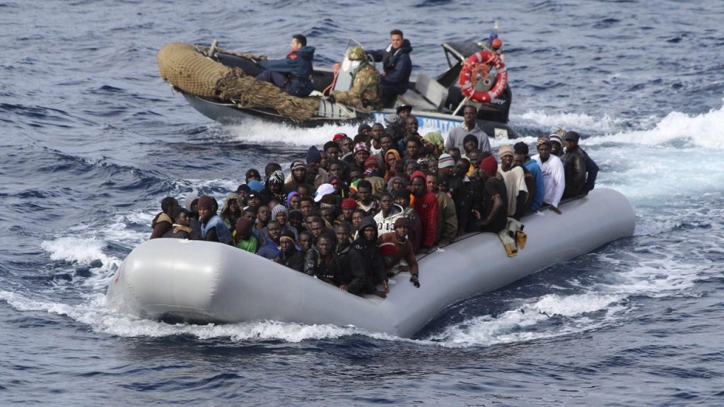 Migrants sit in a boat during a rescue operation by Italian navy off the coast of the south of the Italian island of Sicily in this November 28, 2013 picture provided by the Italian Marina Militare. About 350 migrants, who were travelling in four separate boats were rescued on Thursday in the operation called Mare Nostrum, Italian navy said. Picture taken November 28. REUTERS/Marina Militare/Handout via Reuters (ITALY - Tags: SOCIETY IMMIGRATION MARITIME TPX IMAGES OF THE DAY) ATTENTION EDITORS - THIS IMAGE WAS PROVIDED BY A THIRD PARTY. FOR EDITORIAL USE ONLY. NOT FOR SALE FOR MARKETING OR ADVERTISING CAMPAIGNS. THIS PICTURE IS DISTRIBUTED EXACTLY AS RECEIVED BY REUTERS, AS A SERVICE TO CLIENTS - RTX15XEX